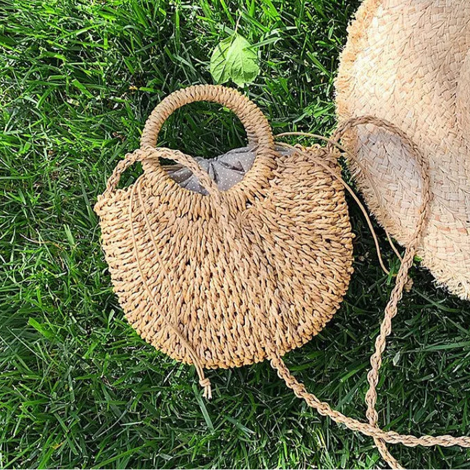 Borsa paglia intrecciata semicircolare in paglia naturale, beige e khaki, con manici rotondi e versione con fiocco Ribbon, vista frontale su fondo neutro