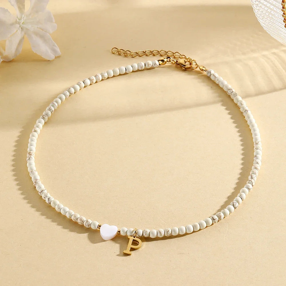 Choker boho con perline, cuore in conchiglia e iniziale in acciaio – collana personalizzata stile 2025