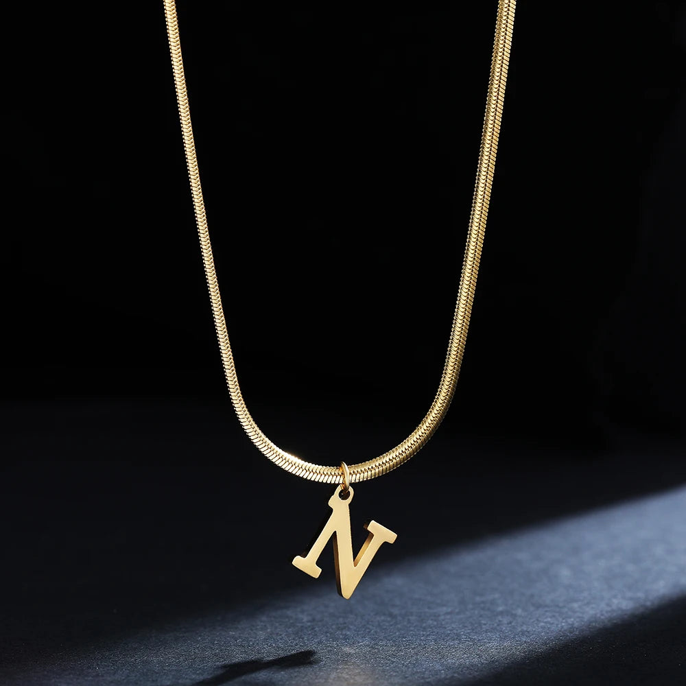 Collana iniziale A–Z in acciaio placcato oro con snake chain – pendente minimal su collare clavicolare