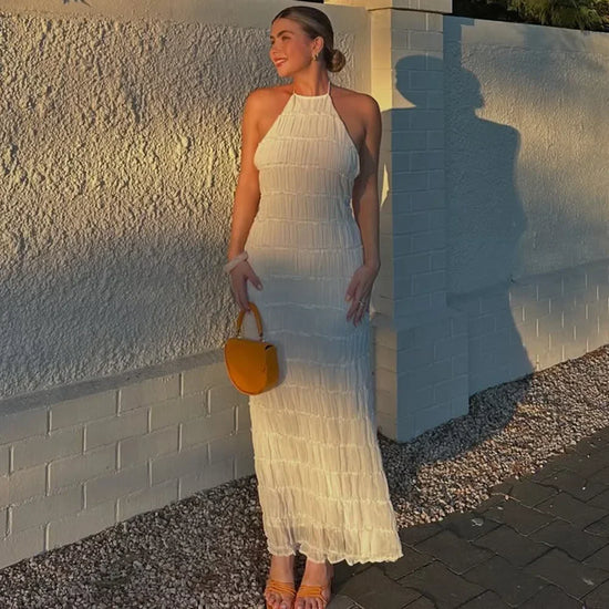 abito lungo donna con schiena scoperta e pieghe elegante