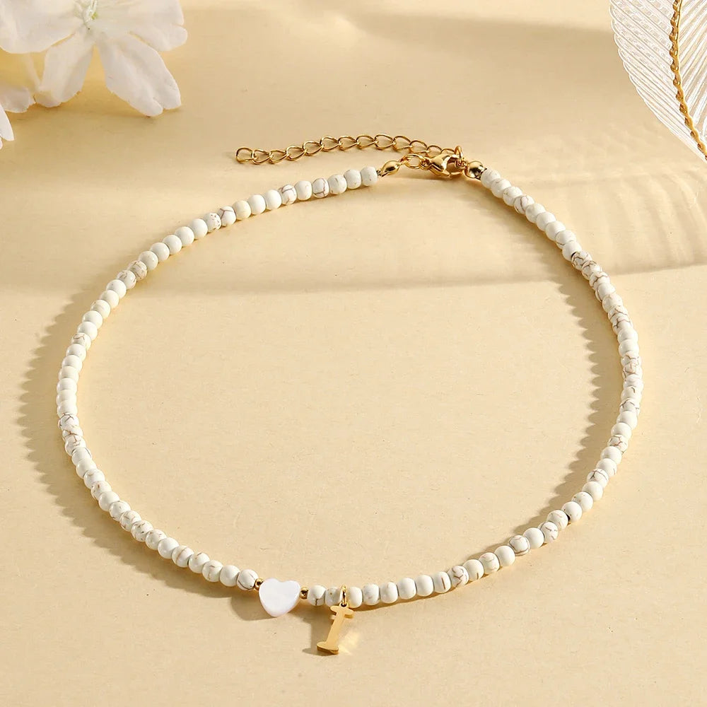 Choker boho con perline, cuore in conchiglia e iniziale in acciaio – collana personalizzata stile 2025