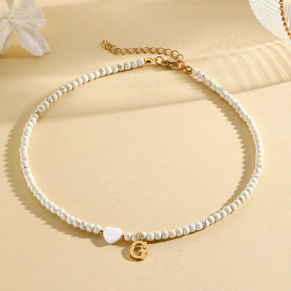 Choker boho con perline, cuore in conchiglia e iniziale in acciaio – collana personalizzata stile 2025